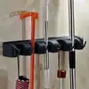 Suport de perete tip organizator pentru maturi si mop, 6 cuiere pliabile, Negru